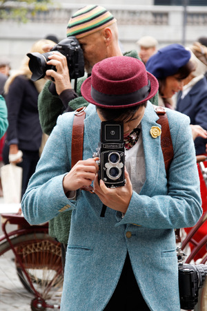 STOCKHOLM - SEPT 19, 2015: Photographer in blue tweed jacket  with retro camera in the Bike in Tweed event September 19, 2015 in Stockholm, Swedenのeditorial素材