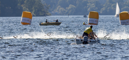 STOCKHOLM - AUG 22, 2015: Chaos of swimming arms in the water and rescue boats in the Men's ITU World Triathlon series event August 22, 2015 in Stockholm, Swedenのeditorial素材