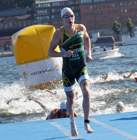 STOCKHOLM - AUG 22, 2015: Swimmer Henri Schoeman (RSA) climbing up from the water in the Men's ITU World Triathlon series event August 22, 2015 in Stockholm, Swedenのeditorial素材