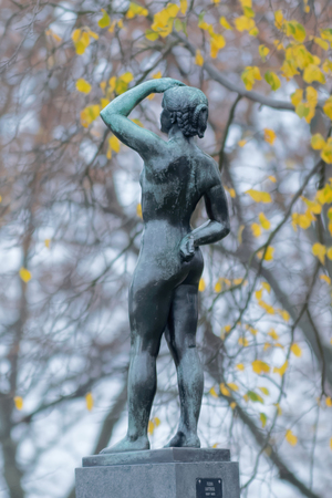 STOCKHOLM - NOV 15, 2015: Sculpture called 'Standing girl in evening sun" made by the artist Anders Jonssons, raised in Vanadislunden in the year 1955 in central Stockholm, Sweden.のeditorial素材