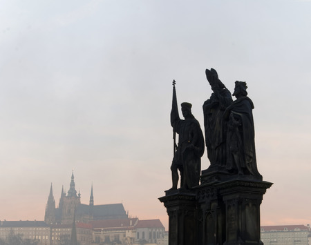 PRAGUE, CZECHOSLOVAKIA - DEC 07, 2015: Statue on Charles bridge in Prague. The royal castle in the background. December 07, 2015 in Prague, Czechoslovakiaのeditorial素材