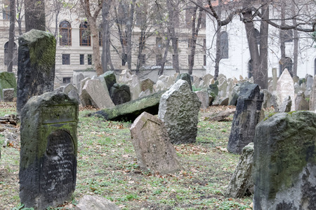 PRAGUE, CZECHIA - DEC 04, 2015: Old Jewish cemetery with lots of ancient headstones in disorder and a church in the background. December 04, 2015 in Prague, Czechiaのeditorial素材