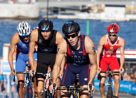 STOCKHOLM, SWEDEN - AUG 23, 2015: Tommy Zaferes and a group of triathlon competitors cycling uphill in the Men's ITU World Triathlon series event August 23, 2015 in Stockholm, Swedenのeditorial素材
