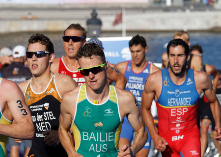 STOCKHOLM, SWEDEN - AUG 23, 2015: Close-up of group of running triathletes Bailie, Stel, Hernandez wearing sun glasses in the Men's ITU World Triathlon series event August 23, 2015 in Stockholm, Swedenのeditorial素材