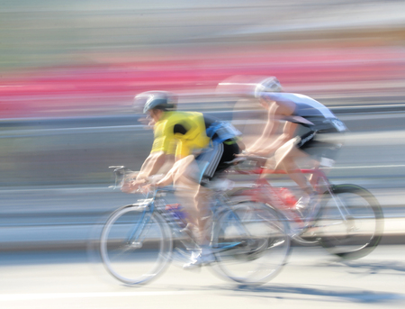 STOCKHOLM - AUG 23, 2015: Two rapid cycling men on a black, the speed makes it un-sharp at ITU World Triathlon event in Stockholm, 2015のeditorial素材