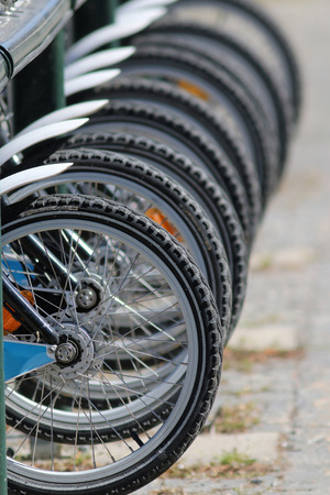 Lots of bicycle weels on parked bicycles