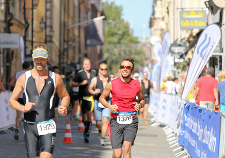 STOCKHOLM - AUG 23, 2015: Group of runners in the triathlon event in bright sunlight at ITU World Triathlon event in Stockholm, 2015のeditorial素材