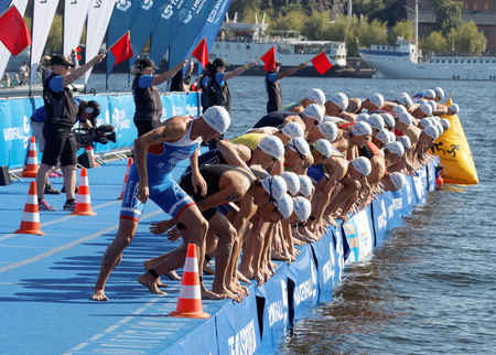 STOCKHOLM - AUG 22, 2015: Group of male swimming competitors in colorful swimsuits when the start signal goes in the Mens's ITU World Triathlon series event August 22, 2015 in Stockholm, Swedenのeditorial素材