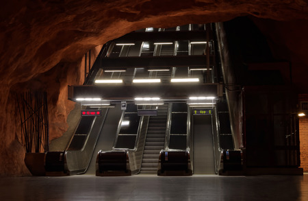 STOCKHOLM - JAN 28, 2016: Escalator in the beautiful orange subway station Radhuset in Stockholm. ...