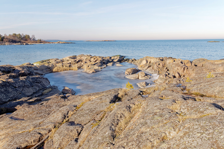 Rocks, ice and sea in march a beautiful spring / winter day in the archipelagoの写真素材