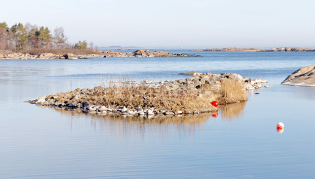 Coast, cliffs, islet and ocean a sunny day during spring time in scandinaviaの写真素材