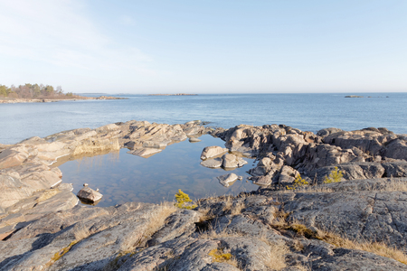 Coast, cliffs, islet and ocean a sunny day during spring time in scandinaviaの写真素材