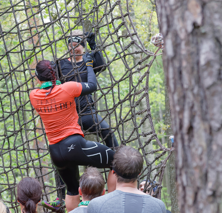 STOCKHOLM, SWEDEN - MAY 14, 2016: Two woman climbing up a net in the obstacle race Tough Viking Event in Sweden, May 14, 2016のeditorial素材