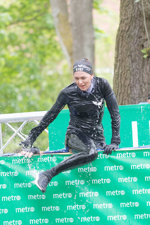 STOCKHOLM, SWEDEN - MAY 14, 2016: Woman jumping out of a tank of ice cold water in the Ice cube obstacle in the obstacle race Tough Viking Event in Sweden, May 14, 2016のeditorial素材