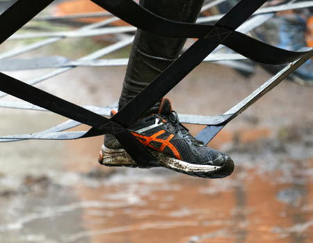 STOCKHOLM, SWEDEN - MAY 14, 2016: Foot climbing a net obstacle in the obstacle race Tough Viking Event in Sweden, May 14, 2016のeditorial素材