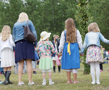 VADDO, SWEDEN - JUNE 23, 2016: Children and adults dancing around the Maypole, celebrating the Midsummer in Sweden, June 23, 2016のeditorial素材
