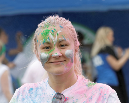 STOCKHOLM, SWEDEN - MAY 22, 2016: Smiling young woman covered with color powder in the Color Run Event in Sweden, May 22, 2016のeditorial素材