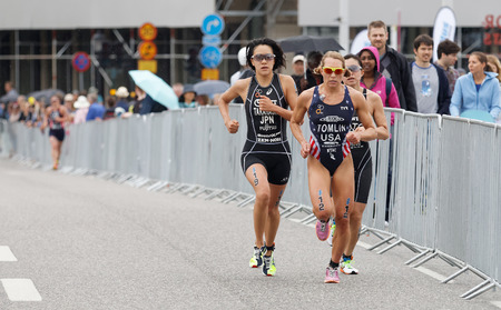STOCKHOLM - JUL 02, 2016: Triathletes Takahashi and Renee Tomlin running in the Women's ITU World Triathlon series event July 02, 2016 in Stockholm, Swedenのeditorial素材