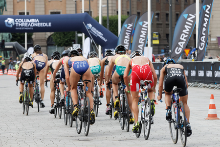 STOCKHOLM - JUL 02, 2016: Rear view of large group of triathlete cyclists Zaferes, Hewitt, Ueda, Vilic andcompetitors in the Women's ITU World Triathlon series event July 02, 2016 in Stockholm, Swedenのeditorial素材