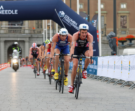 STOCKHOLM, SWEDEN - JUL 02, 2016: Group of male triathlete cyclists, Jonathan Brownlee (GBR), Raoul Shaw (FRA) and competitors in the Men's ITU World Triathlon series event July 02, 2016 in Stockholm, Swedenのeditorial素材
