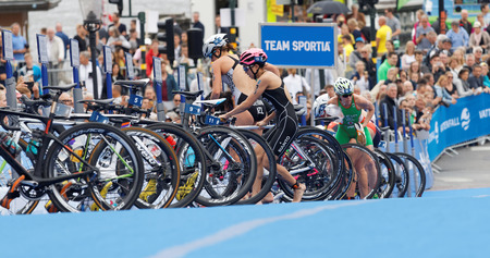 STOCKHOLM - JUL 02, 2016: Switching from cycle to running in the transition zone in the Women's ITU World Triathlon series event July 02, 2016 in Stockholm, Swedenのeditorial素材