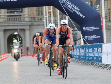 STOCKHOLM, SWEDEN - JUL 02, 2016: Group of male triathlete cyclists, Jonathan Brownlee (GBR), Raoul Shaw (FRA) and competitors in the Men's ITU World Triathlon series event July 02, 2016 in Stockholm, Swedenのeditorial素材