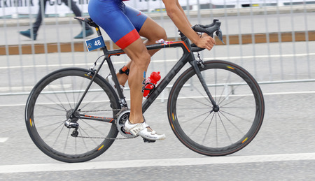 STOCKHOLM, SWEDEN - JUL 02, 2016: Side view of male triathlete cyclist without torso in the Men's ITU World Triathlon series event July 02, 2016 in Stockholm, Swedenのeditorial素材