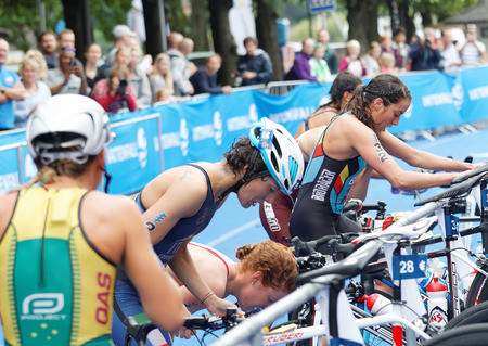 STOCKHOLM - JUL 02, 2016: Triathletes change from swimming to cycling the transition zone in the transition zone in the Women's ITU World Triathlon series event July 02, 2016 in Stockholm, Swedenのeditorial素材