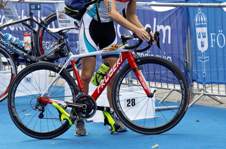 STOCKHOLM - JUL 02, 2016: Closeup of a professional triathlete preparing the cycle in the Women's ITU World Triathlon series event July 02, 2016 in Stockholm, Swedenのeditorial素材