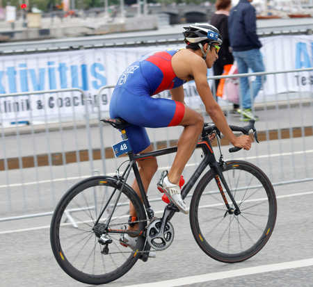 STOCKHOLM, SWEDEN - JUL 02, 2016: Side view of male triathlete cyclist Luis Miguel Velasques in the Men's ITU World Triathlon series event July 02, 2016 in Stockholm, Swedenのeditorial素材