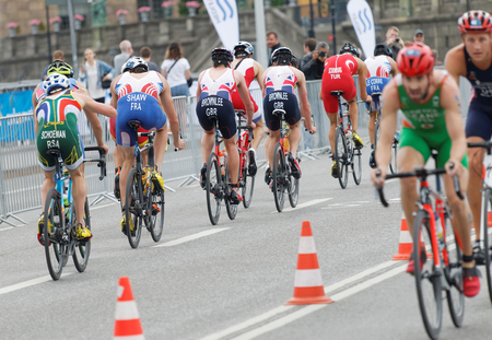 STOCKHOLM, SWEDEN - JUL 02, 2016: Rear view of a large group of male triathlete cyclists in the Men's ITU World Triathlon series event July 02, 2016 in Stockholm, Swedenのeditorial素材