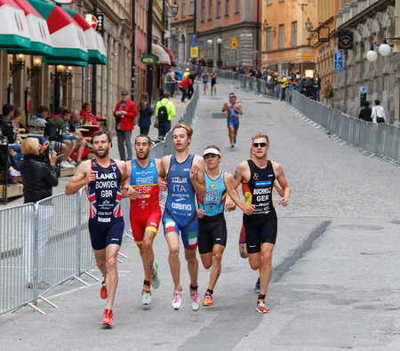 STOCKHOLM - JUL 02, 2016: Running triathletes in the old town of Stockholm in the Men's ITU World Triathlon series event July 02, 2016 in Stockholm, Swedenのeditorial素材