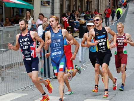 STOCKHOLM - JUL 02, 2016: Side view of running triathletes in a curve in the Men's ITU World Triathlon series event July 02, 2016 in Stockholm, Swedenのeditorial素材