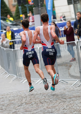 STOCKHOLM - JUL 02, 2016: Rear view of running triathletes Alistair and Jonathan Brownlee in the Men's ITU World Triathlon series event July 02, 2016 in Stockholm, Swedenのeditorial素材