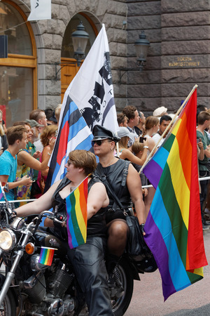 STOCKHOLM, SWEDEN - JUL 30, 2016: Two woman dressed in leather clothes on a motorcycle decorated with pride flags in the Pride parade July 30, 2016 in Stockholm, Swedenのeditorial素材
