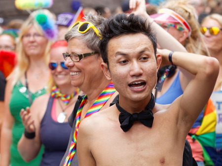 STOCKHOLM, SWEDEN - JUL 30, 2016: Asian boy with bow tie and naked torso in the Pride parade July 30, 2016 in Stockholm, Swedenのeditorial素材