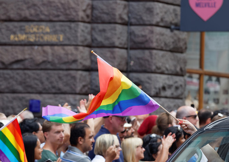 STOCKHOLM, SWEDEN - JUL 30, 2016: HPeople waiving the rainbow pride flag in the Pride parade July 30, 2016 in Stockholm, Swedenのeditorial素材