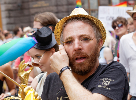STOCKHOLM, SWEDEN - JUL 30, 2016: Man with beard and golden eyelashes in the Pride parade July 30, 2016 in Stockholm, Swedenのeditorial素材