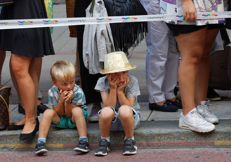 STOCKHOLM, SWEDEN - JUL 30, 2016: Two young boys looking boored when waiting for the Pride parade in the Pride parade July 30, 2016 in Stockholm, Swedenのeditorial素材