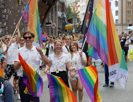 STOCKHOLM, SWEDEN - JUL 30, 2016: Dancing girls and boys with rainbow pride flags and soap bubbles in the Pride parade July 30, 2016 in Stockholm, Swedenのeditorial素材