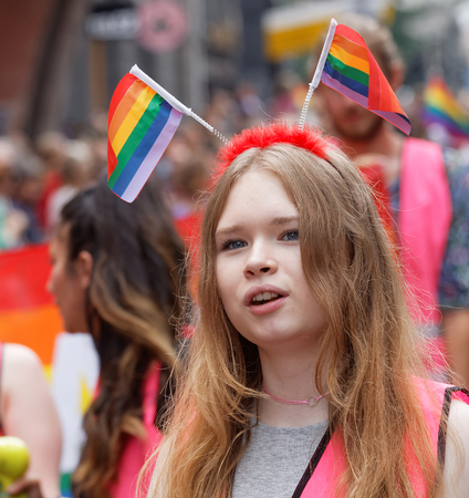 STOCKHOLM, SWEDEN - JUL 30, 2016: Young girl wearing with rainbow pride flags in her hair in the Pride parade July 30, 2016 in Stockholm, Swedenのeditorial素材