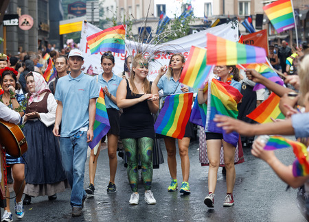 STOCKHOLM, SWEDEN - JUL 30, 2016: Young, happy girls and boys waiving the rainbow pride flags in the Pride parade July 30, 2016 in Stockholm, Swedenのeditorial素材