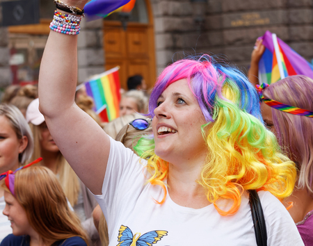 STOCKHOLM, SWEDEN - JUL 30, 2016: YSmiling, happy girl wearing a rainbow wig in the Pride parade July 30, 2016 in Stockholm, Swedenのeditorial素材