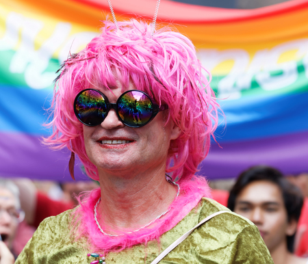 STOCKHOLM, SWEDEN - JUL 30, 2016: Senior smiling transvestite man with a pink wig in the Pride parade July 30, 2016 in Stockholm, Swedenのeditorial素材