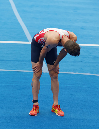STOCKHOLM - JUL 02, 2016: Tired triathlete Adam Bowden after the finish in the Men's ITU World Triathlon series event July 02, 2016 in Stockholm, Swedenのeditorial素材