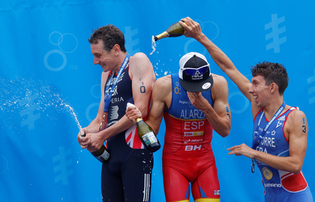 STOCKHOLM - JUL 02, 2016: The medalist triathletes Alistair and Jonathan Brownlee and Pierre Le Corre squirting champagne on the podium in the Men's ITU World Triathlon series event July 02, 2016 in Stockholm, Swedenのeditorial素材