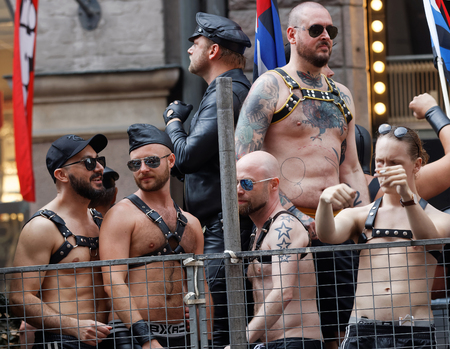 STOCKHOLM, SWEDEN - JUL 30, 2016: Group of macho men dressed in leather wearing sunglasses standing on a truck bed in the Pride parade July 30, 2016 in Stockholm, Swedenのeditorial素材