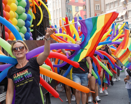 STOCKHOLM, SWEDEN - JUL 30, 2016: Smiling caucasian girls, colorful balloons and rainbow pride flags in the Pride parade in the Pride parade in the Pride parade July 30, 2016 in Stockholm, Swedenのeditorial素材