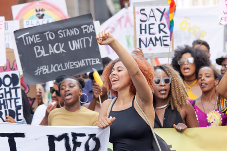 STOCKHOLM, SWEDEN - JUL 30, 2016: Demonstrating women with afro hair holding a signs in the Pride Parade in the Pride parade July 30, 2016 in Stockholm, Swedenのeditorial素材