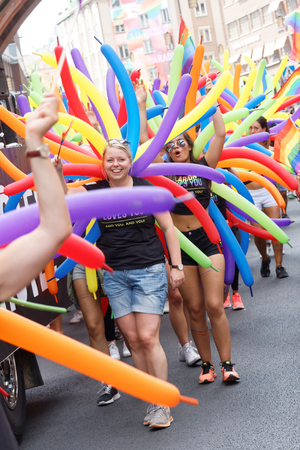 STOCKHOLM, SWEDEN - JUL 30, 2016: Smiling caucasian girls and colorful balloons in the Pride parade in the Pride parade in the Pride parade July 30, 2016 in Stockholm, Swedenのeditorial素材